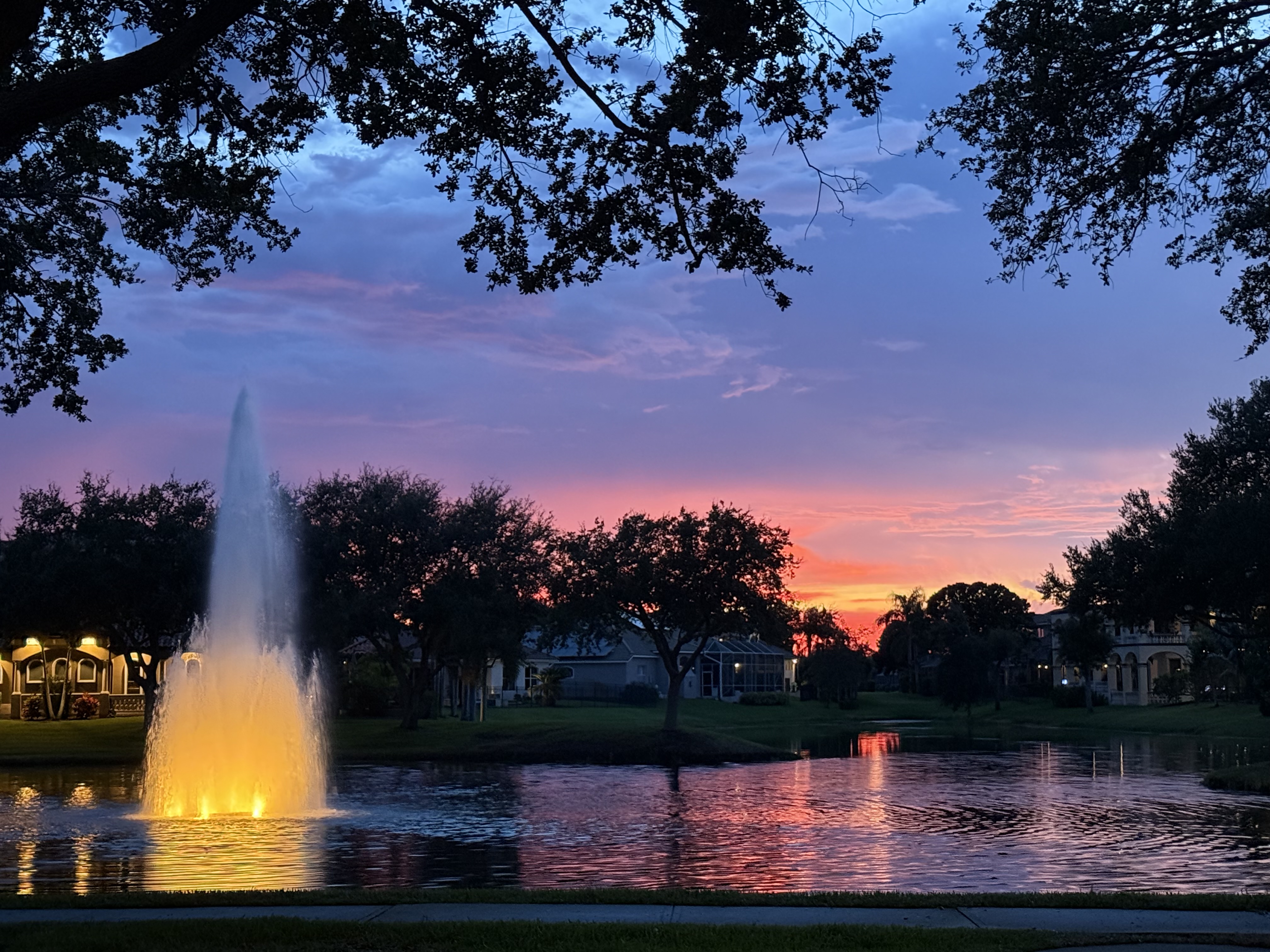 Casa Bella community at dusk — fountain and pond